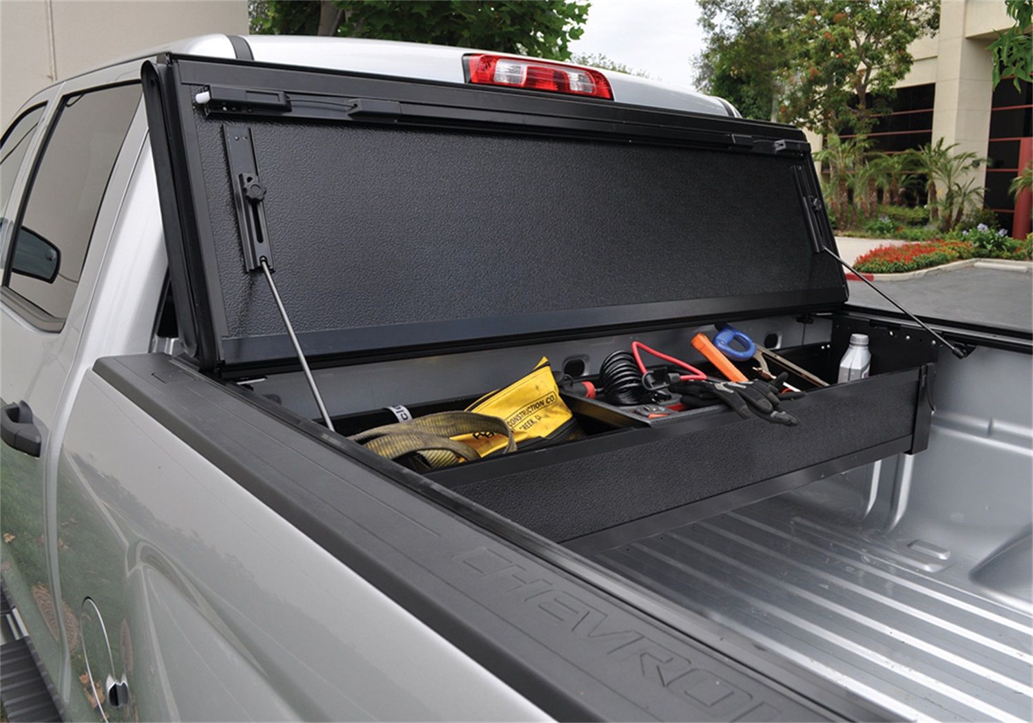 Folding tonneau deals cover with toolbox